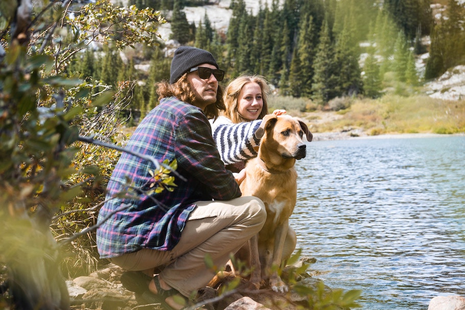 Couple with dog by river